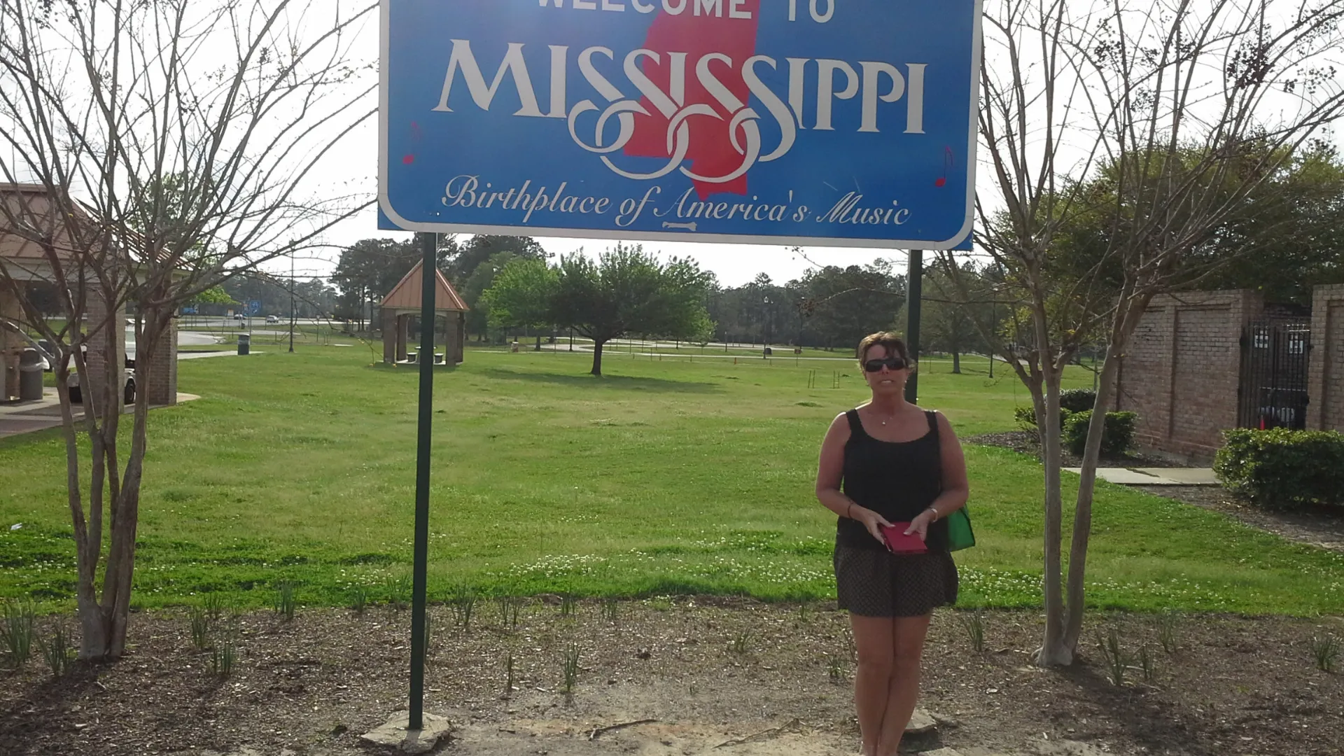 "Jane at the Missippi State line, capturing the journey one sign at a time."